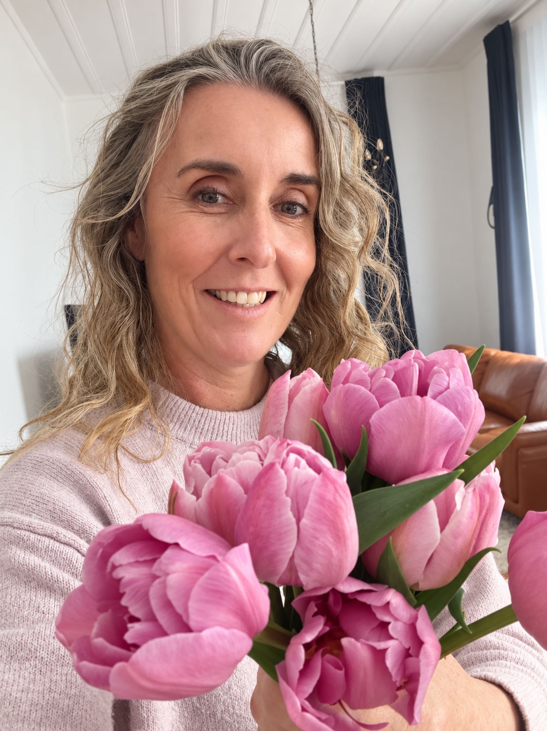 Creative Staging founder holding a bouquet of pink tulips