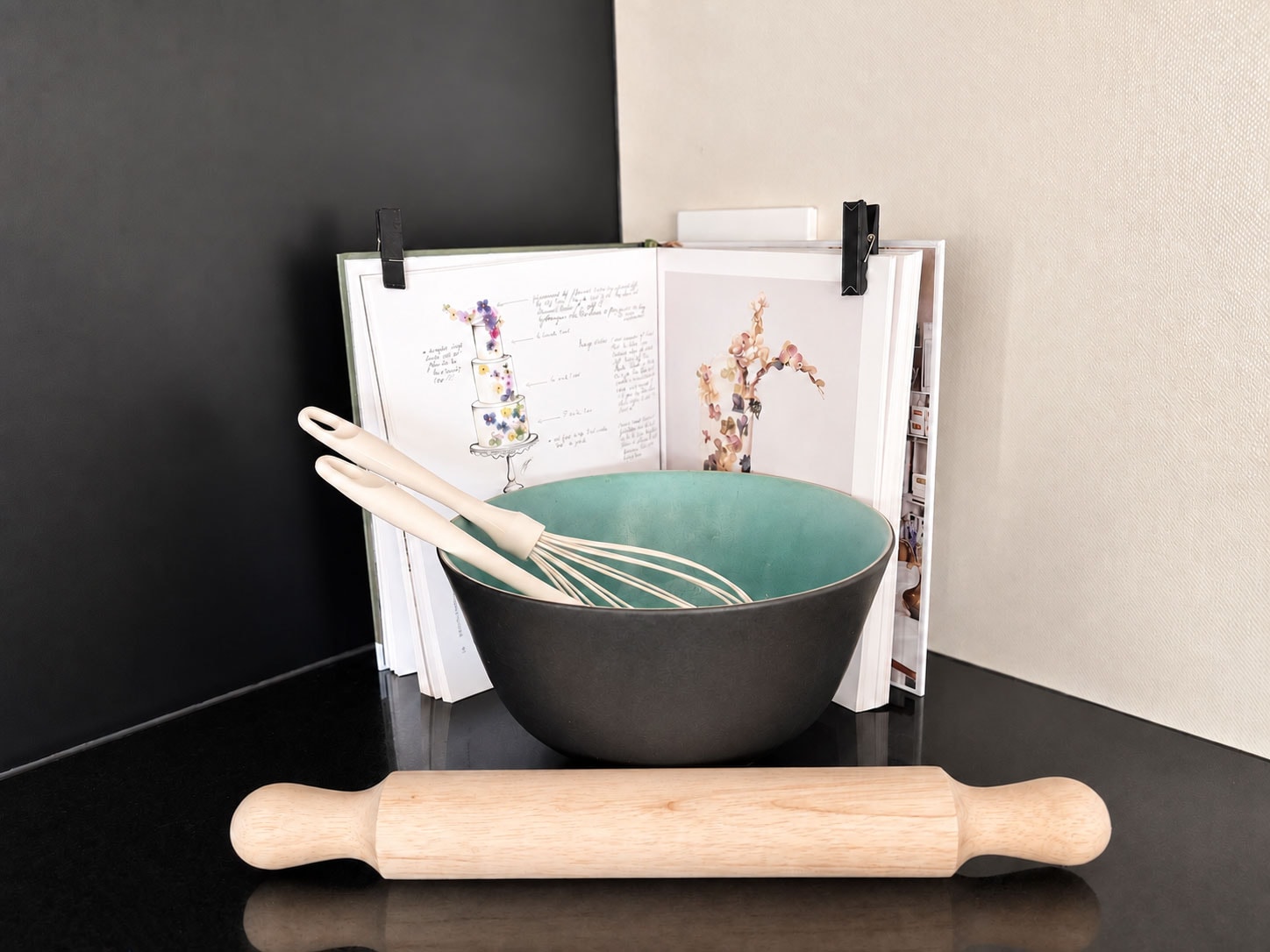 Baking tools, mixing bowl and hand-drawn sketches arranged on a table
