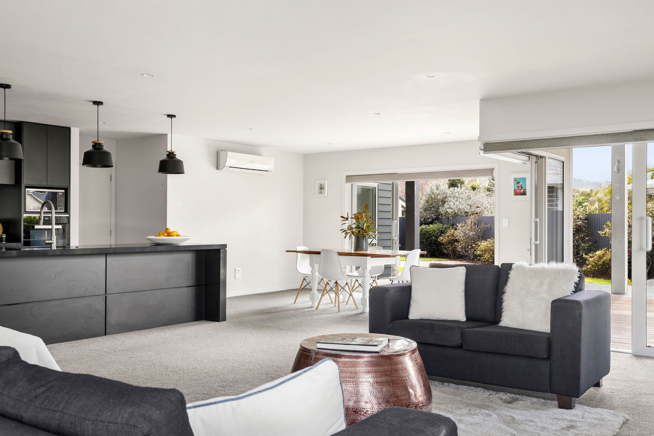 Open-plan living, kitchen and dining space with modern furnishings